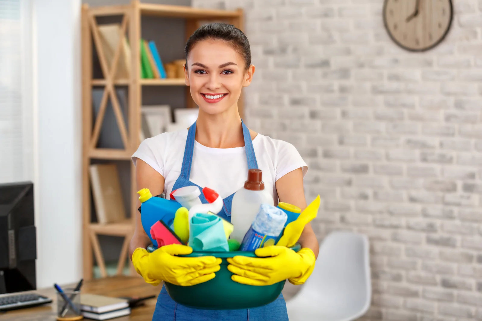 Illustrative photo of a cleaner holding supplies